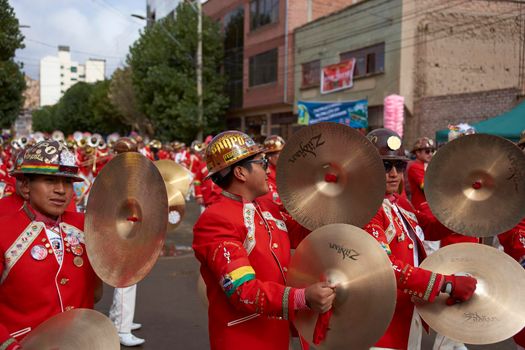 ORURO, BOLIVIA - FEBRUARY 25, 2017: Band of a Morenada dance group in colourful outfits parading through the mining city of Oruro on the Altiplano of Bolivia during the annual Oruro Carnival.