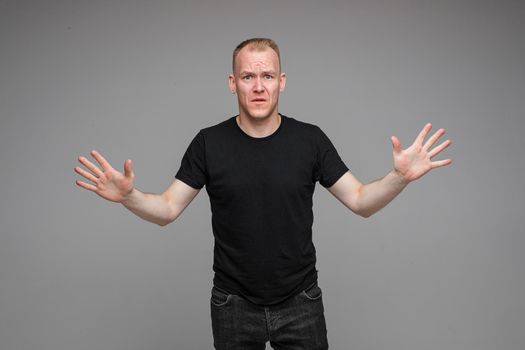picture of caucasian man keeps his hands near the head rages isolated on grey background