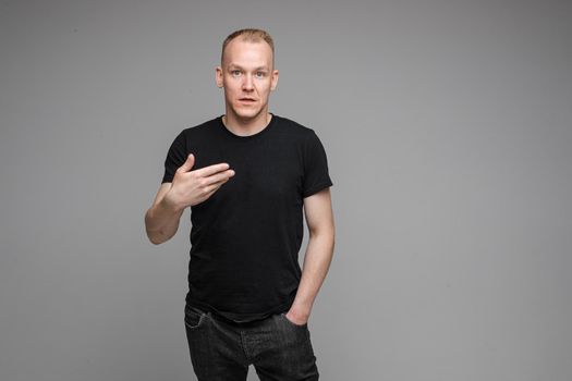 picture of handsome caucasian male isn't uderstand something isolated on grey background
