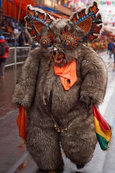 ORURO, BOLIVIA - FEBRUARY 25, 2017: Diablada dancer in ornate bear costume parading through the mining city of Oruro on the Altiplano of Bolivia during the annual carnival.