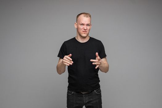 picture of caucasian man keeps his hands near the head rages isolated on grey background