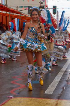 ORURO, BOLIVIA - FEBRUARY 25, 2017: Female Morenada dancers in colourful costumes parading through the mining city of Oruro on the Altiplano of Bolivia during the annual Oruro Carnival.