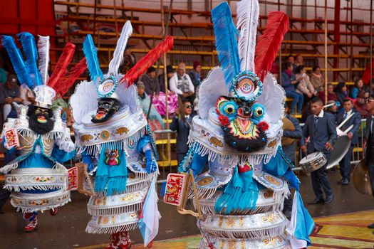 ORURO, BOLIVIA - FEBRUARY 25, 2017: Morenada dancers in ornate costumes parade through the mining city of Oruro on the Altiplano of Bolivia during the annual carnival.