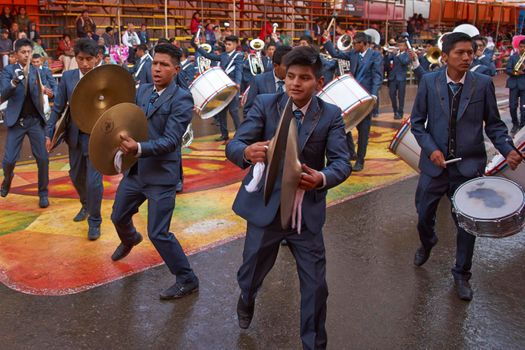 ORURO, BOLIVIA - FEBRUARY 25, 2017: Band of a Morenada dance group in colourful outfits parading through the mining city of Oruro on the Altiplano of Bolivia during the annual Oruro Carnival.