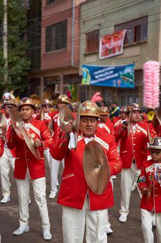 ORURO, BOLIVIA - FEBRUARY 25, 2017: Band of a Morenada dance group in colourful outfits parading through the mining city of Oruro on the Altiplano of Bolivia during the annual Oruro Carnival.