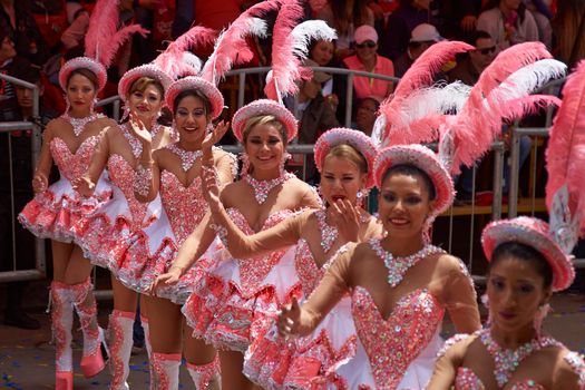 ORURO, BOLIVIA - FEBRUARY 25, 2017: Female Morenada dancers in colourful costumes parading through the mining city of Oruro on the Altiplano of Bolivia during the annual Oruro Carnival.