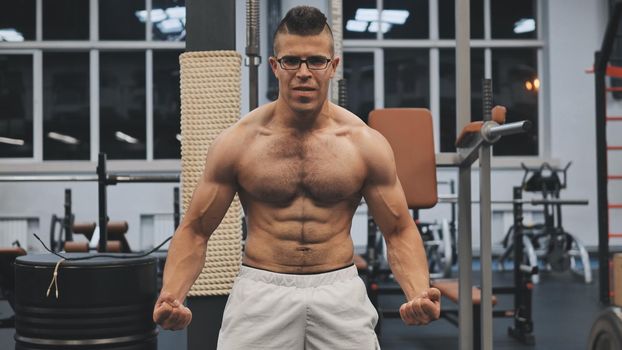Muscular arab man posing in the gym