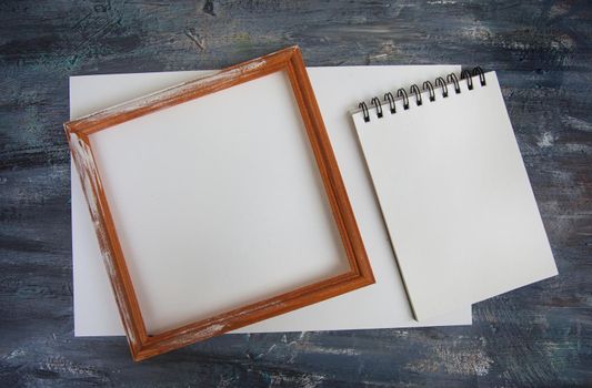 Artistic notepads with empty pages on black wood table background for portfolio design