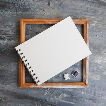 Artistic notepads with empty pages on black wood table background for portfolio design