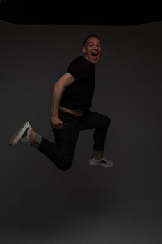 cheerful cacuasian male rejoices in studio on white background, backstage of a photosession