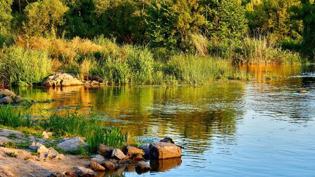 a large natural stream of water flowing in a channel to the sea, a lake, or another such stream.