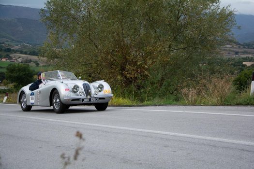 CAGLI , ITALY - OTT 24 - 2020 : jaguar xk120 ots roadsters on an old racing car in rally Mille Miglia 2020 the famous italian historical race (1927-1957)