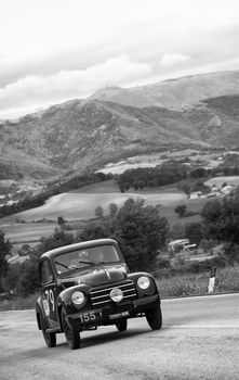 CAGLI , ITALY - OTT 24 - 2020 : FIAT 500 C on an old racing car in rally Mille Miglia 2020 the famous italian historical race (1927-1957)