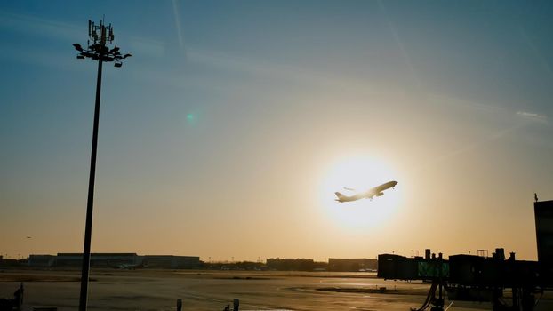 Plane taking off sky sunset sun dusk in airport China. Beijing