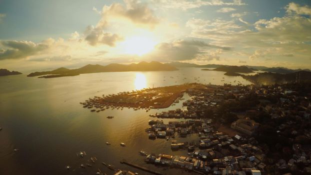 Aerial view Coron city with slums and poor district. Palawan. Busuanga island. Evening time and sunset. Fisheye view