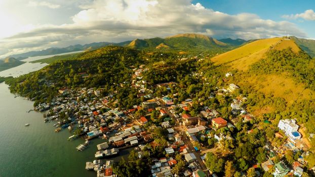 Aerial view Coron city with slums and poor district. Palawan. Busuanga island. Evening time and sunset. Fisheye view