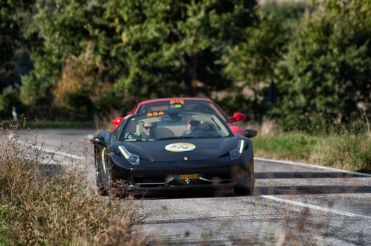 CAGLI , ITALY - OTT 24 - 2020 : FERRARI 458 SPIDER on an old racing car in rally Mille Miglia 2020 the famous italian historical race (1927-1957)