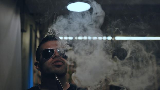 Arabic jordanian young man smokes a hookah