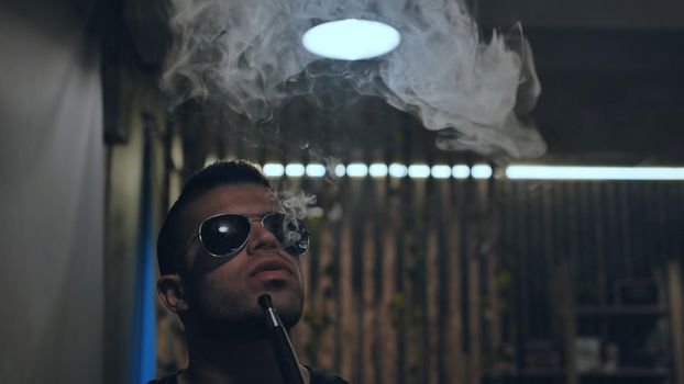Arabic jordanian young man smokes a hookah