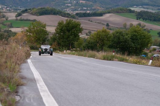 CAGLI , ITALY - OTT 24 - 2020 : ASTON MARTIN LE MANS on an old racing car in rally Mille Miglia 2020 the famous italian historical race (1927-1957)