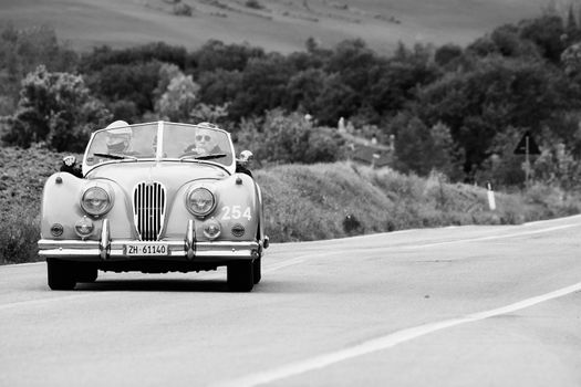 CAGLI , ITALY - OTT 24 - 2020 : JAGUAR XK 140 OTS SE 1954 on an old racing car in rally Mille Miglia 2020 the famous italian historical race (1927-1957