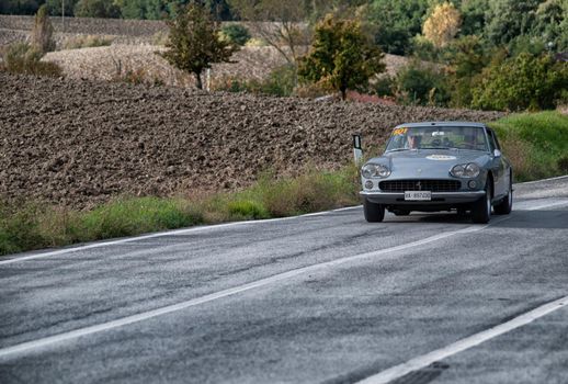 CAGLI , ITALY - OTT 24 - 2020 : FERRARI 330 GT 2+2 on an old racing car in rally Mille Miglia