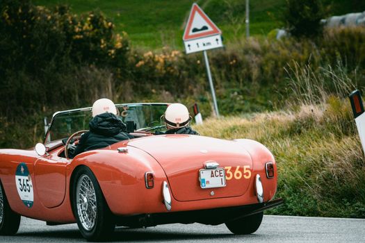 CAGLI , ITALY - OTT 24 - 2020 : AC ACE 1956 on an old racing car in rally Mille Miglia 2020 the famous italian historical race (1927-19