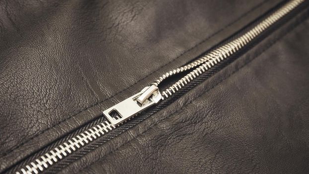 Chrome metal zipper on a leather jacket close-up