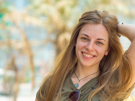 Portrait of a young and smiling girl in summer.