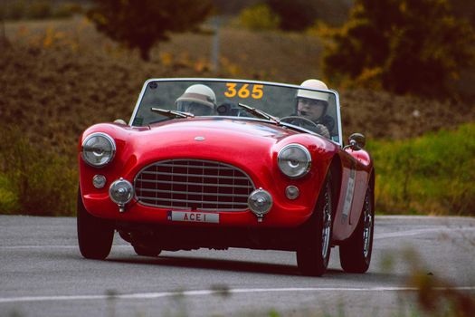 CAGLI , ITALY - OTT 24 - 2020 : AC ACE 1956 on an old racing car in rally Mille Miglia 2020 the famous italian historical race (1927-1957