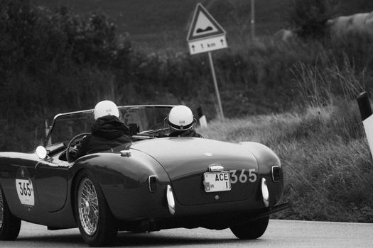 CAGLI , ITALY - OTT 24 - 2020 : AC ACE 1956 on an old racing car in rally Mille Miglia 2020 the famous italian historical race (1927-1957