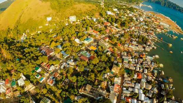 Aerial view Coron city with slums and poor district. Palawan. Busuanga island. Evening time and sunset. Fisheye view