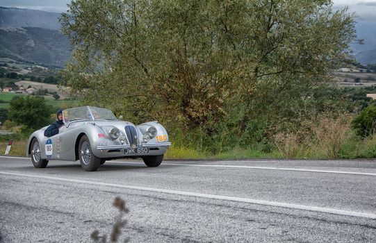 CAGLI , ITALY - OTT 24 - 2020 : jaguar xk120 ots roadsters on an old racing car in rally Mille Miglia 2020 the famous italian historical race (1927-1957)