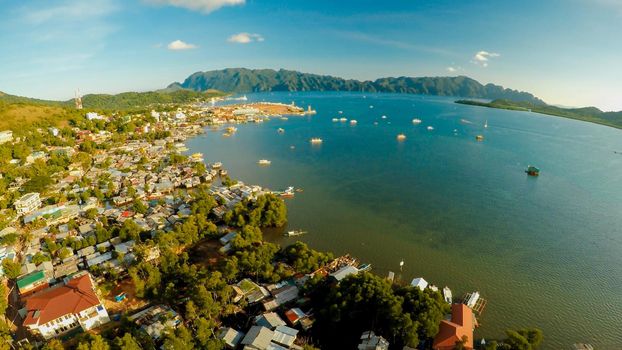 Aerial view Coron city with slums and poor district. Palawan. Busuanga island. Evening time and sunset. Fisheye view