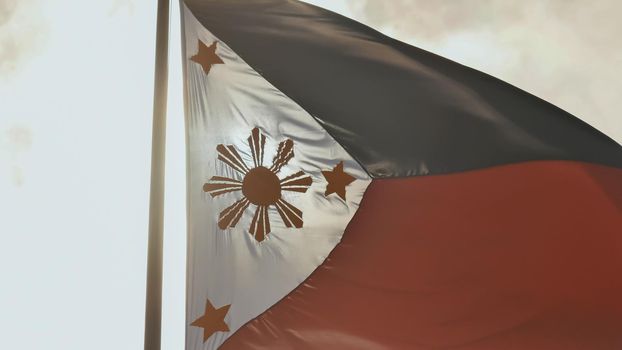 Flying bicolor flag of the Philippines with central golden sun representing the provinces and stars the islands
