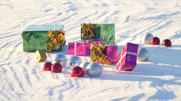 Christmas gifts in a field on snow in a sunny, frosty and clear weather outdoors
