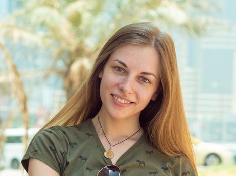 Portrait of a young and smiling girl in summer.