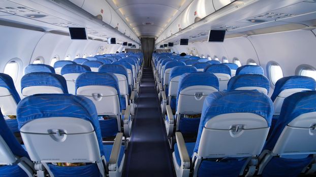 Empty aircraft cabin during flight. Blue salon