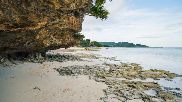 Beautiful wild tropical beach near Anda with granite rocks. Bohol Island. Philippines