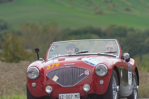 CAGLI , ITALY - OTT 24 - 2020 : AUSTIN HEALEY 100/4 BN2 1956 on an old racing car in rally Mille Miglia 2020 the famous italian historical race (1927-1957)