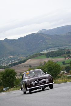 CAGLI , ITALY - OTT 24 - 2020 : FIAT 1100 E GHIA SUOPER GIOIELLO on an old racing car in rally Mille Miglia 2020 the famous italian historical race (1927-1957)