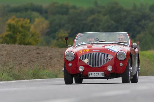 CAGLI , ITALY - OTT 24 - 2020 : AUSTIN HEALEY 100/4 BN2 1956 on an old racing car in rally Mille Miglia 2020 the famous italian historical race (1927-1957)