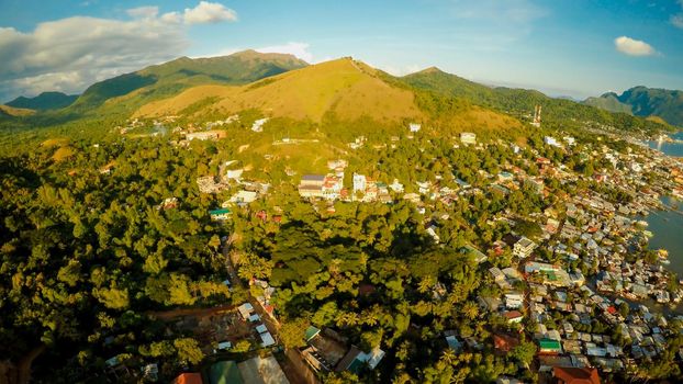 Aerial view Coron city with slums and poor district. Palawan. Busuanga island. Evening time and sunset. Fisheye view