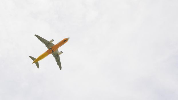 The plane flies in the sky in cloudy weather