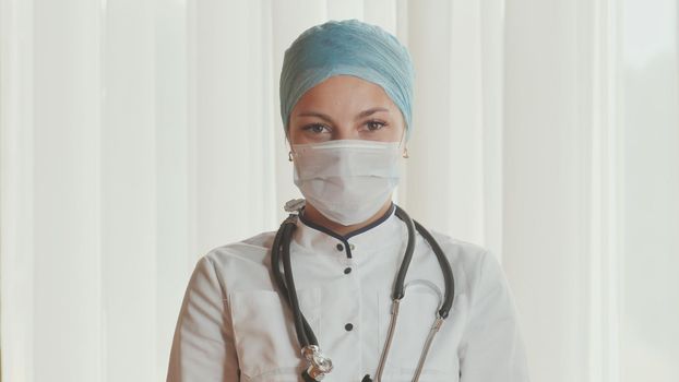 Portrait of a young female doctor in a mask