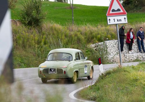 CAGLI , ITALY - OTT 24 - 2020 : RENAULT DAUPHINE 1957 on an old racing car in rally Mille Miglia 2020 the famous italian historical race (1927-1957