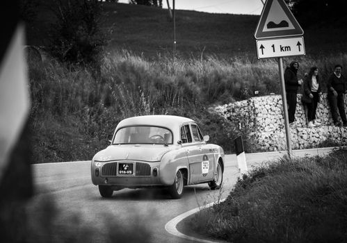 CAGLI , ITALY - OTT 24 - 2020 : RENAULT DAUPHINE 1957 on an old racing car in rally Mille Miglia 2020 the famous italian historical race (1927-1957