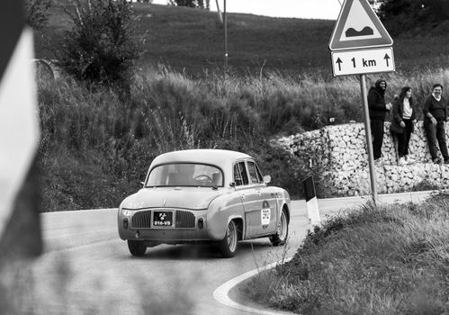 CAGLI , ITALY - OTT 24 - 2020 : RENAULT DAUPHINE 1957 on an old racing car in rally Mille Miglia 2020 the famous italian historical race (1927-1957