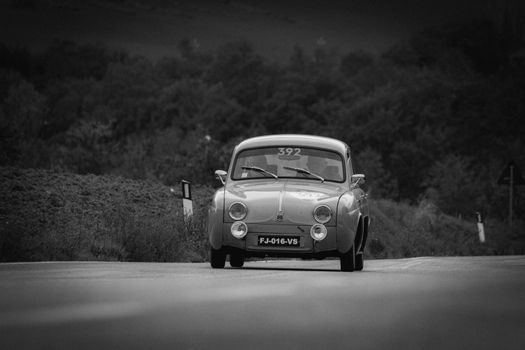 CAGLI , ITALY - OTT 24 - 2020 : RENAULT DAUPHINE 1957 on an old racing car in rally Mille Miglia 2020 the famous italian historical race (1927-1957