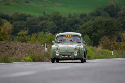 CAGLI , ITALY - OTT 24 - 2020 : RENAULT DAUPHINE 1957 on an old racing car in rally Mille Miglia 2020 the famous italian historical race (1927-1957